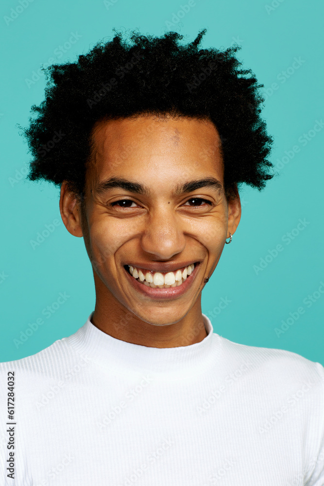 young adult man with afro hairstyle smiling, looking at camera, studio shot headshot young adult man with afro hairstyle smiling, looking at camera, studio shot headshot