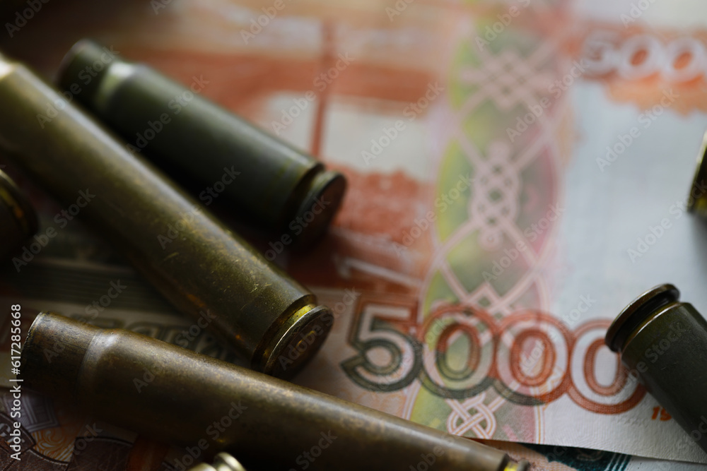 Bullets lie on the russians money money with inscription five thousands rubles top view Bullets lie on the russians money money with inscription five thousands rubles top view