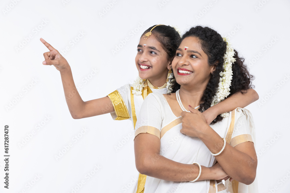 South Indian woman smiling with her daughter South Indian woman smiling with her daughter