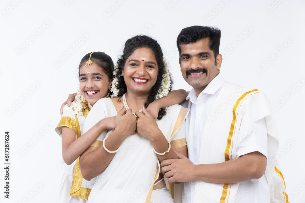 Smiling south indian parents and daughter posing in traditional clothing. Smiling south indian parents and daughter posing in traditional clothing.