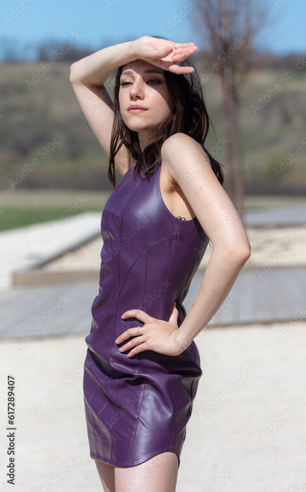 Beautiful young woman in a purple dress posing outdoor Beautiful young woman in a purple dress posing outdoor
