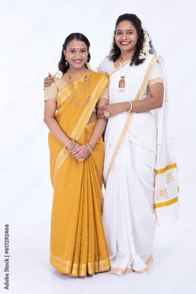 Two South Indian woman posing in traditional clothing Two South Indian woman posing in traditional clothing