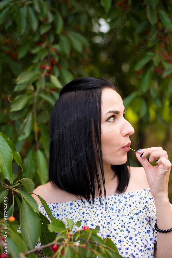 Beautiful woman eating cherry berries for fun Beautiful woman eating cherry berries for fun