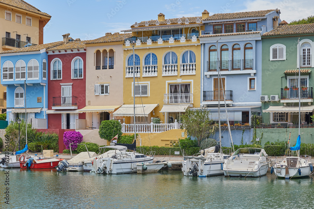 Panoramic view of colorfull houses and moored yachts in Port Saplaya