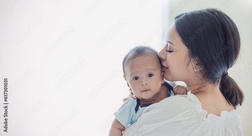 Close up portrait of beautiful young asian or caucasian mother day kissing her newborn baby in hospital. Healthcare and medical love asia woman lifestyle mother's day concept with copy space. Close up portrait of beautiful young asian or caucasian mother day kissing her newborn baby in hospital. Healthcare and medical love asia woman lifestyle mother's day concept with copy space.