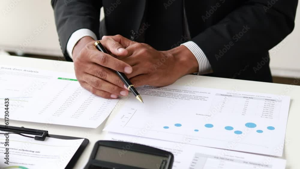 Businessman is reviewing monthly sales documents for analysis and marketing plans for more sales growth, they are the founders of young companies co-founding startups. Sales management concept. 4k. Businessman is reviewing monthly sales documents for analysis and marketing plans for more sales growth, they are the founders of young companies co-founding startups. Sales management concept. 4k.