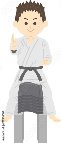 瓦割りをする、男性空手家のイラスト