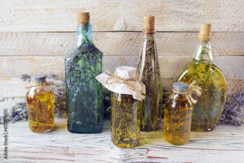 Lavender flowers  tincture bottles and lavender oil jars  on wooden background  natural ingredients  alternative medicine