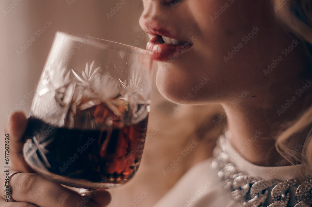 Young girl drinking grape wine