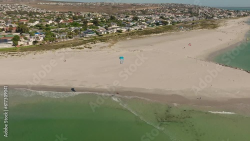 Kitesurfer jumping near the beach at Langebaan, drone shot.