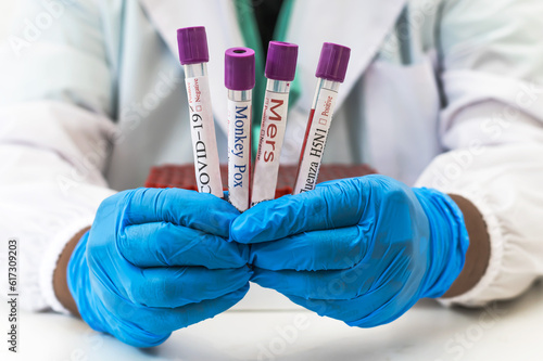 Close up laboratorian holding glass tubes in lab  photo