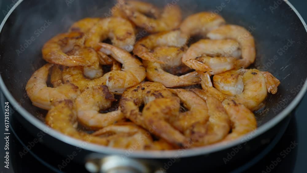 Closeup high angle view delicious shrimps frying in pan with oil. Close-up tasty nutritional food cooking indoors Closeup high angle view delicious shrimps frying in pan with oil. Close-up tasty nutritional food cooking indoors