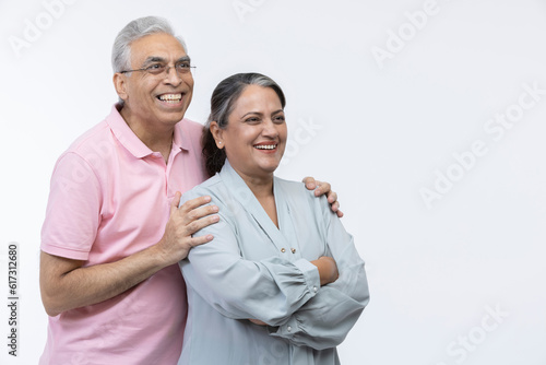 Photography Portrait of loving senior Indian couple, standing on white background