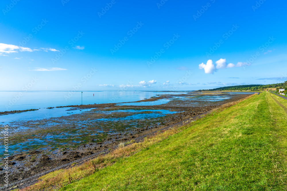 View, during a beautiful sunny day, from the dike on the south side of the island of Vlieland on a partly dried up Wadden Sea