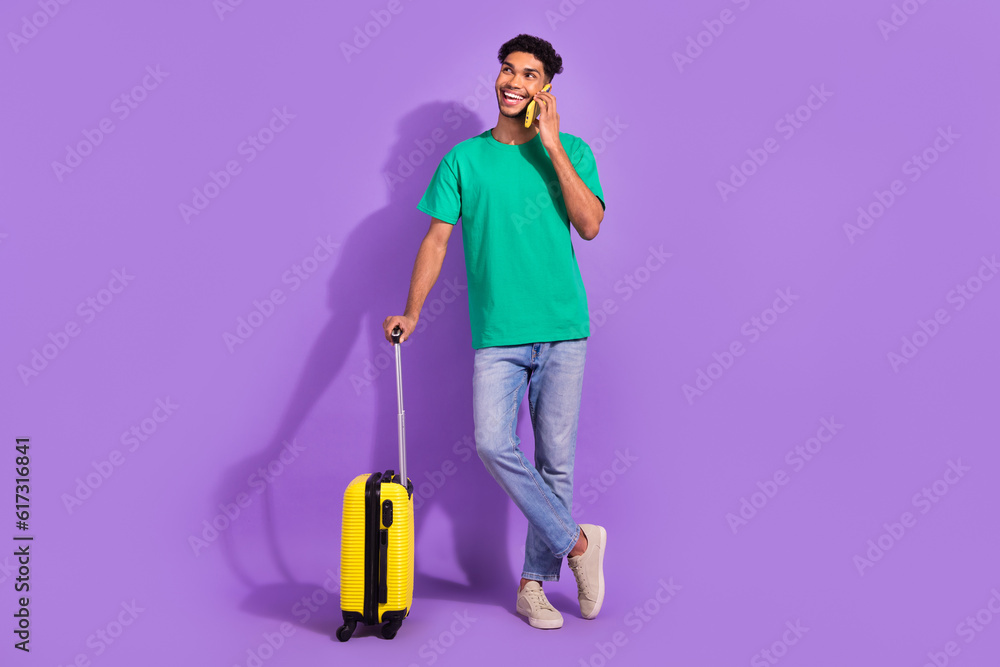Full body photo of handsome man speak telephone hold suitcase isolated on violet color background Full body photo of handsome man speak telephone hold suitcase isolated on violet color background