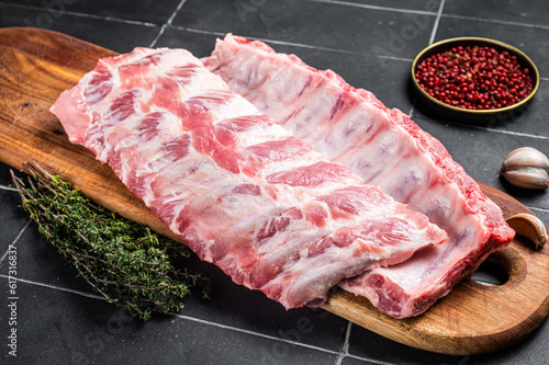 Canvas Print Fresh Pork Spareribs, Raw spare loin ribs on a wooden board with thyme and spices