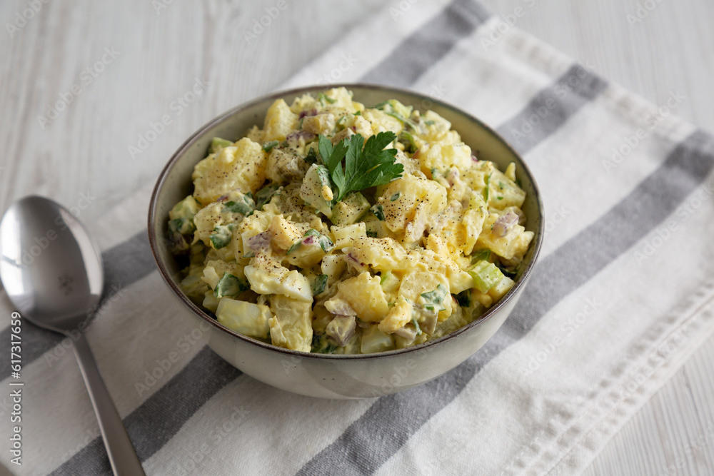 Homemade Potato Egg Salad with Pickles in a Bowl, side view. Homemade Potato Egg Salad with Pickles in a Bowl, side view.