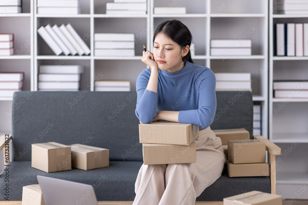 Young asian woman ecommerce SME business stressed leaning on package at home office, stressed headache Startup small business entrepreneur asian woman work package post shipping box delivery parcel Young asian woman ecommerce SME business stressed leaning on package at home office, stressed headache Startup small business entrepreneur asian woman work package post shipping box delivery parcel