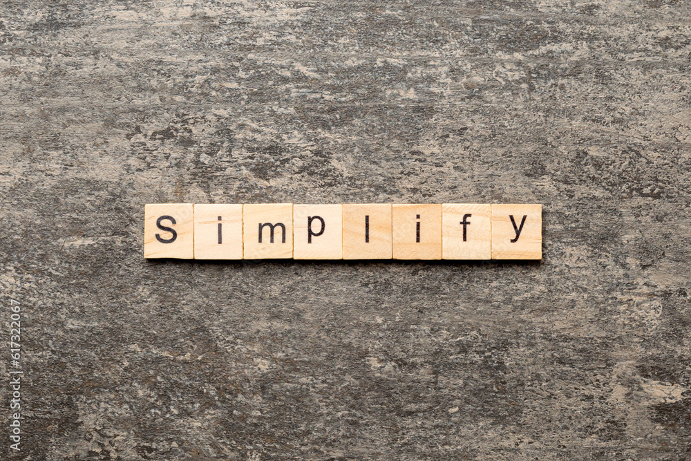 simplify word written on wood block. simplify text on table, concept simplify word written on wood block. simplify text on table, concept