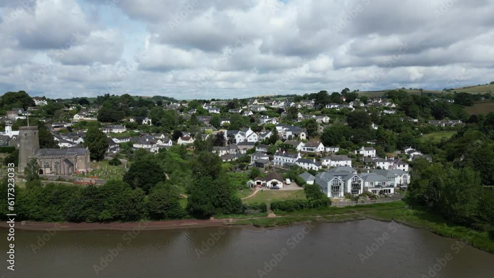 Stoke Gabriel, South Devon, England: DRONE AERIAL VIEWS: The drone tracks right-to-left over the Mill Pond showing the riverside properties of Stoke Gabriel village and St Mary & St Gabriel church. Stoke Gabriel, South Devon, England: DRONE AERIAL VIEWS: The drone tracks right-to-left over the Mill Pond showing the riverside properties of Stoke Gabriel village and St Mary & St Gabriel church.