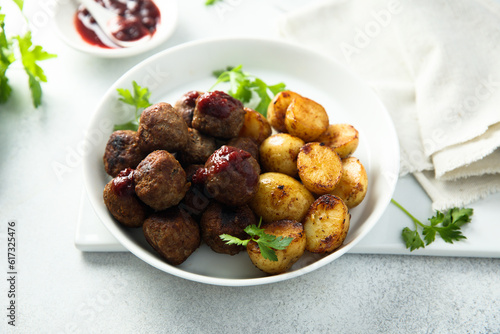 Homemade veal meatballs with potato and berry sauce
