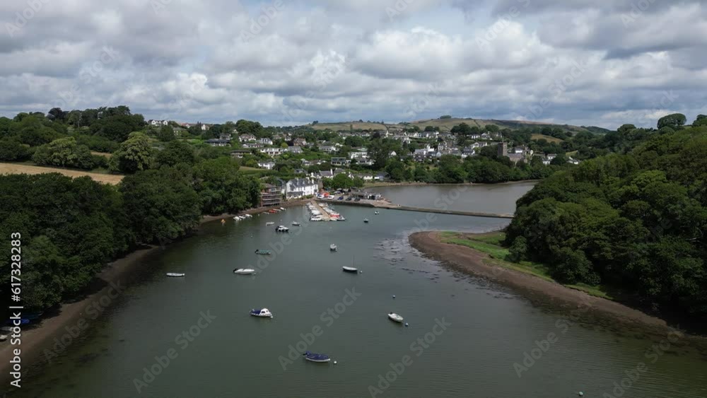 Stoke Gabriel, South Devon, England: DRONE AERIAL VIEWS: The drone flies over boats moored on the River Dart and onwards to the Mill Pond weir with Stoke Gabriel village in the background. Stoke Gabriel, South Devon, England: DRONE AERIAL VIEWS: The drone flies over boats moored on the River Dart and onwards to the Mill Pond weir with Stoke Gabriel village in the background.