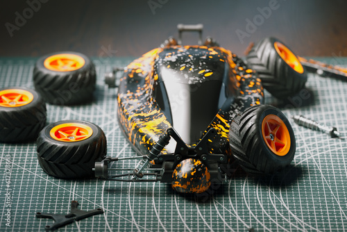 Bilde på lerret Disassembled remote-controlled car laying on a cutting mat with parts around