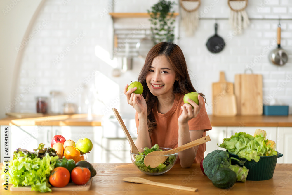 Portrait of beauty body slim healthy asian woman big smile cooking and preparing vegan food healthy holding apple, green apple, dental, teeth, fruit in kitchen at home.Diet.Fitness, healthy food Portrait of beauty body slim healthy asian woman big smile cooking and preparing vegan food healthy holding apple, green apple, dental, teeth, fruit in kitchen at home.Diet.Fitness, healthy food