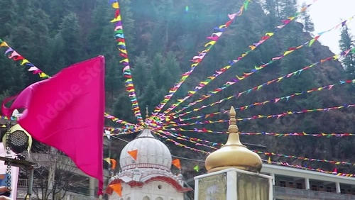 manikaran sahib gurudwara of sikhs religion decorated with flags at day from different angle photo