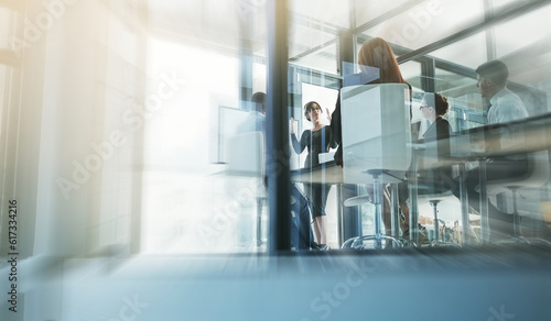 Mentor, woman coaching or business people in presentation for sales report or financial analysis in training. Office blur, leadership or female manager planning vision in a meeting on screen monitor