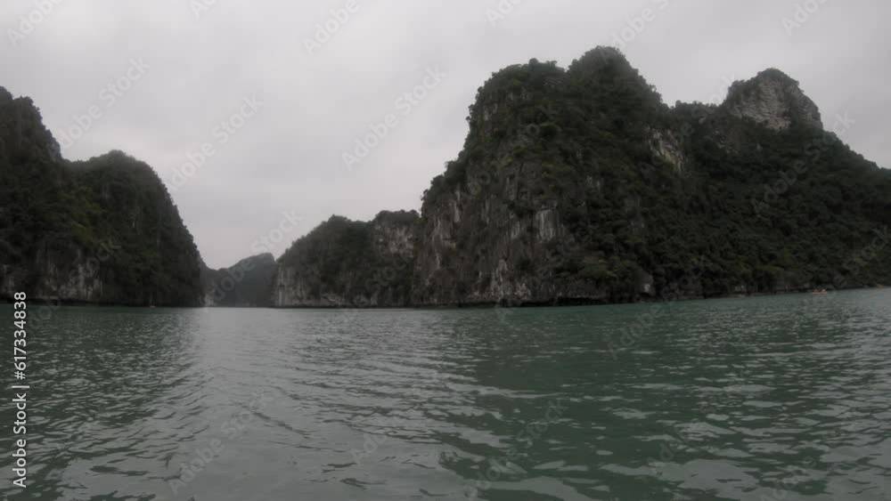 POV Shot of an island nestled within the stunning Halong Bay in Vietnam, captured using a GoPro from a kayak. POV Shot of an island nestled within the stunning Halong Bay in Vietnam, captured using a GoPro from a kayak.