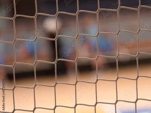 Tournament view through the protective net of a futsal match. photo