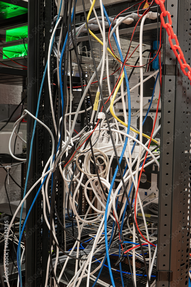 Messy tangled electric cables connecting to industrial lab devices on a ...