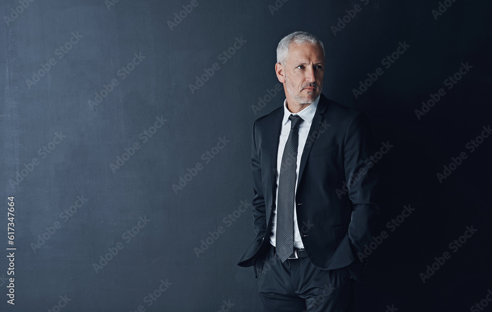 Senior executive, business man and confidence in studio, management and professional mindset on dark background. Male CEO, corporate director and suit with ambition, empowerment and mockup space