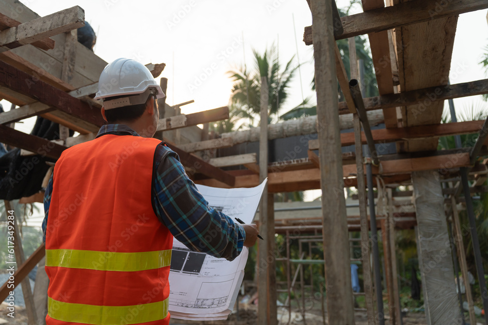 inspector or engineer is inspecting construction and quality assurance new house using a blue print. Engineer or architects or contactor work to build the house before handing it over to the homeowner inspector or engineer is inspecting construction and quality assurance new house using a blue print. Engineer or architects or contactor work to build the house before handing it over to the homeowner