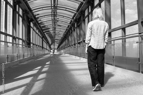 Moscow, Russia - June 18, 2023: a girl walks alone along an overpass