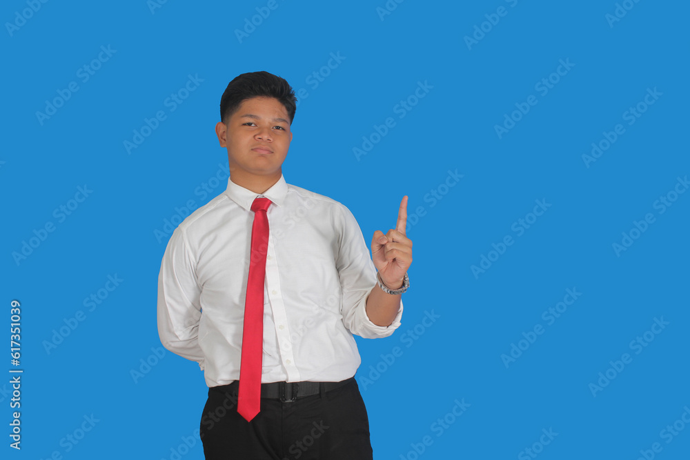 Asian male party cadre in tie pointing up with number one finger smiling confident and happy for election campaign isolated on blue background.
Asian male party cadre in tie pointing up with number one finger smiling confident and happy for election campaign isolated on blue background.