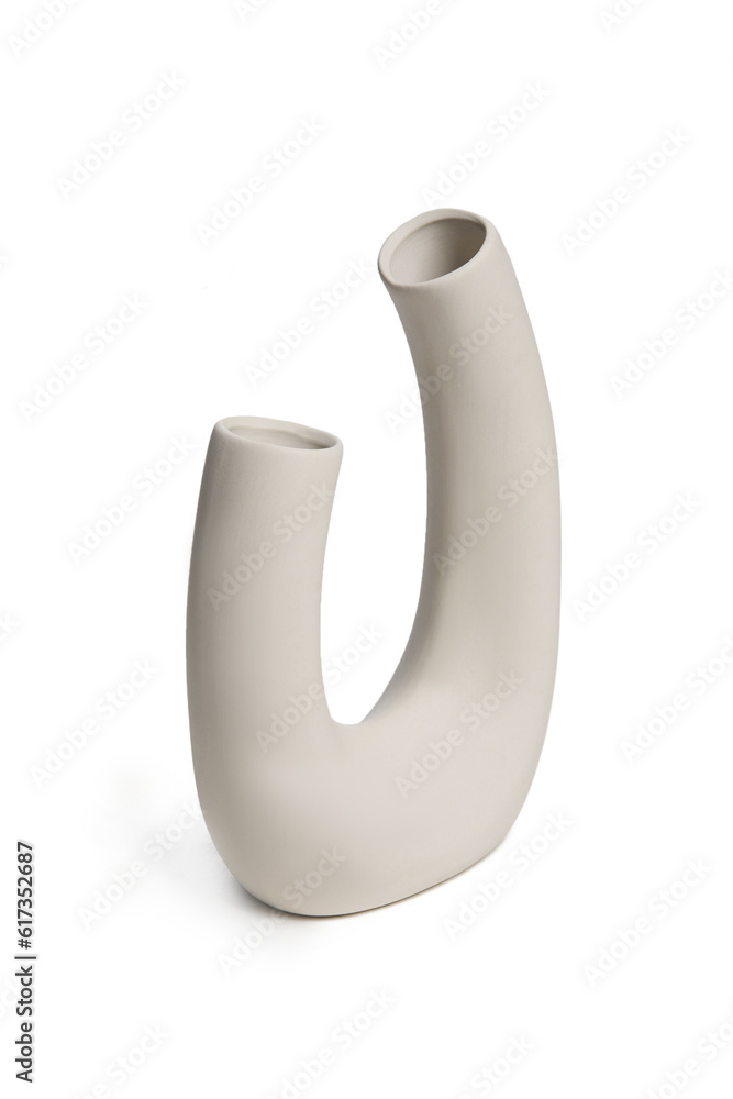 Subject shot of a white matte ceramic vase in a scandinavian style with two holes. The designer vase is isolated on the white background. Subject shot of a white matte ceramic vase in a scandinavian style with two holes. The designer vase is isolated on the white background.
