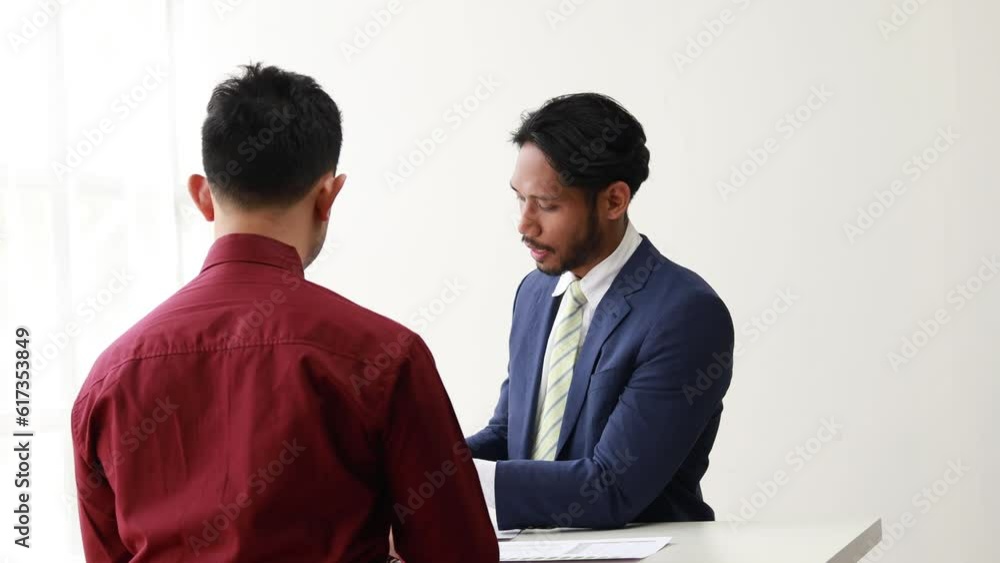 Two business men are discussing business together, they have a business meeting, a meeting of business partners at a start-up company, an agreement and discussion on a plan for growing a company. Two business men are discussing business together, they have a business meeting, a meeting of business partners at a start-up company, an agreement and discussion on a plan for growing a company.