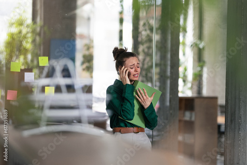 Young sad woman in office  having problem.