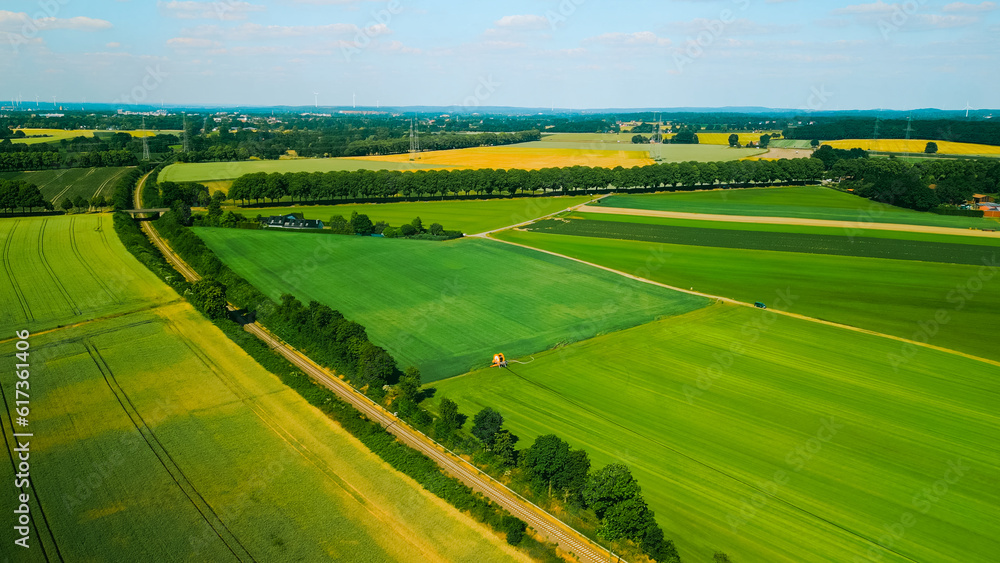 Aerial drone shot of agricultural fields of wheat , corn and other in sunny summer day. Countryside landscape Germany