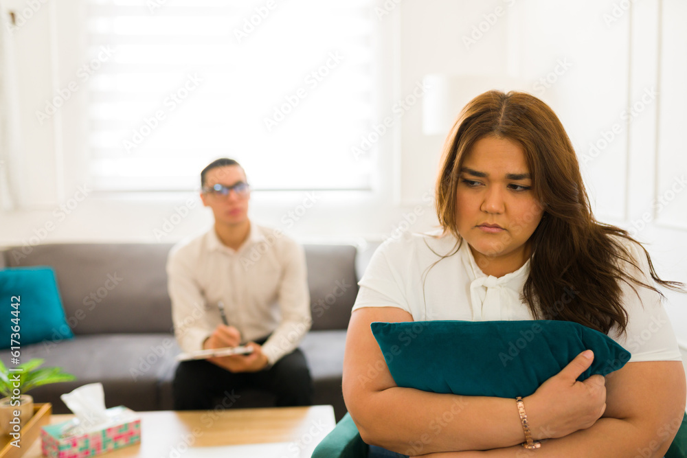 Sad depressed woman ignoring her psychologist therapist Sad depressed woman ignoring her psychologist therapist
