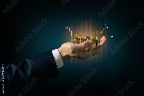 Fotografiet investment and finance concept, businessman holding virtual trading graph and blurred light on hand, stock market, profits and business growth