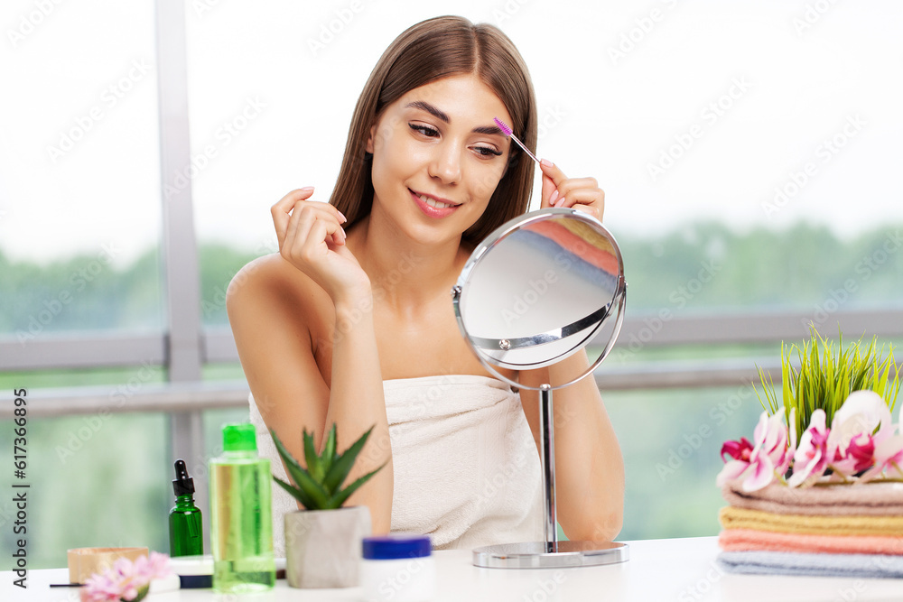 Beautiful woman using mascara on eyelash in bathroom in the morning time