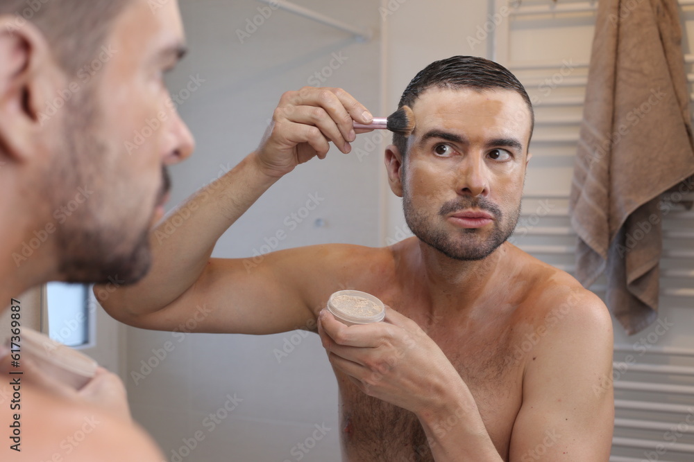 Fototapeta premium Man applying too much make up on face 