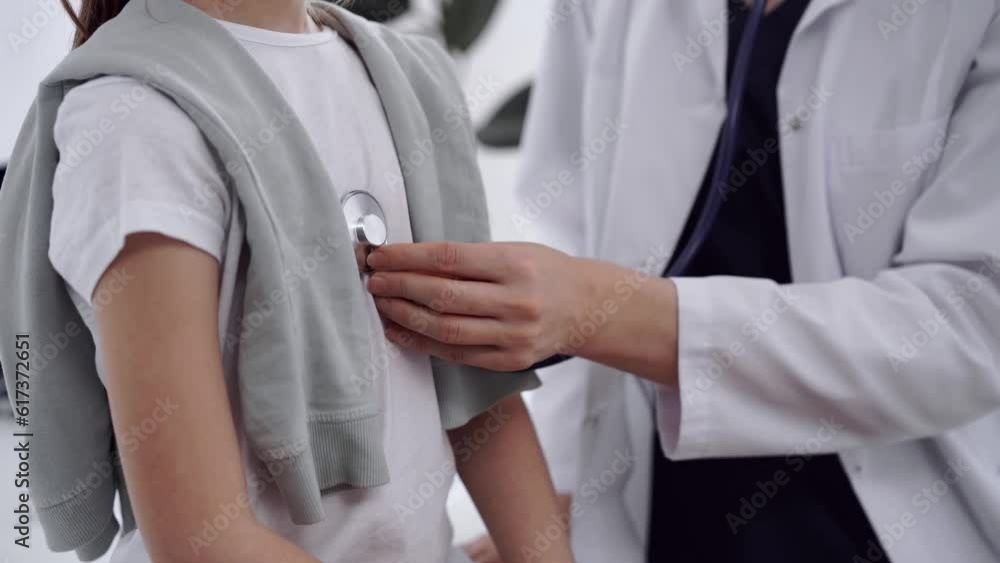 Doctor and patient. Physician is examining girl kid with a stethoscope at usual medical inspection in clinic. Medicine concept Doctor and patient. Physician is examining girl kid with a stethoscope at usual medical inspection in clinic. Medicine concept
