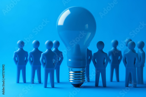 A group of business people gather around a light bulb. Business idea concept