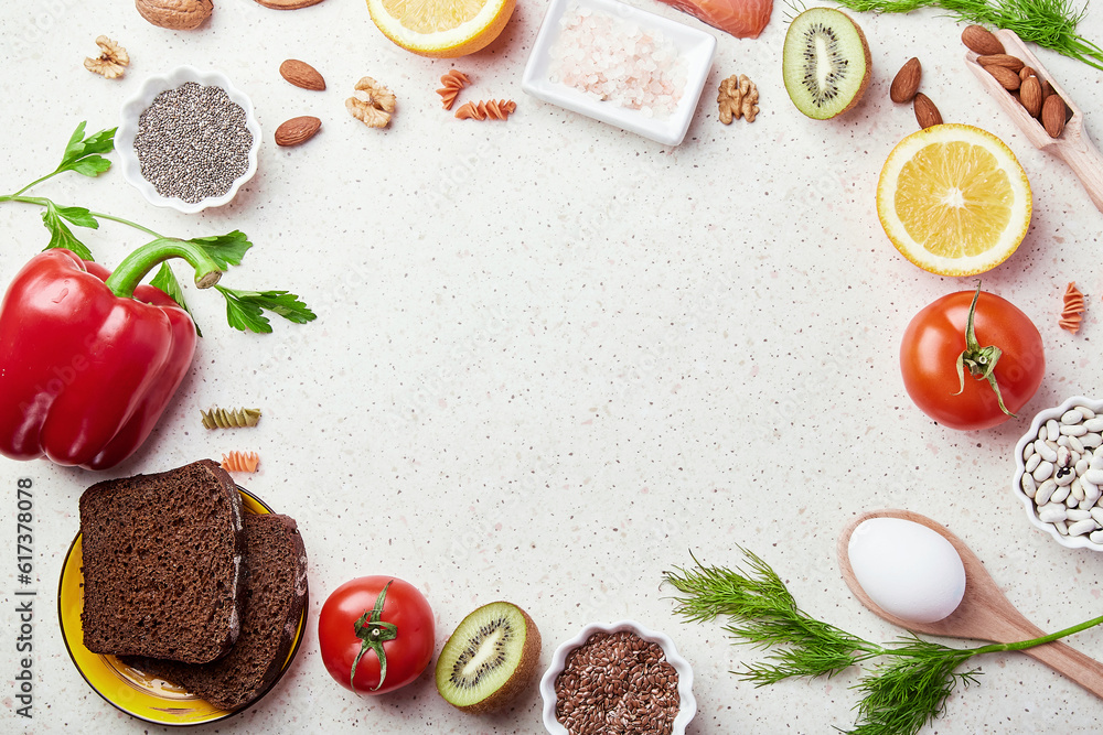 Fodmap healthy diet with copy space in center. Low fodmap ingredients - seafish, vegetables and fruits, nuts, greens, beans, egg, flax seeds, chia seeds. Flat lay Fodmap healthy diet with copy space in center. Low fodmap ingredients - seafish, vegetables and fruits, nuts, greens, beans, egg, flax seeds, chia seeds. Flat lay