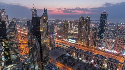 High-rise buildings on Sheikh Zayed Road in Dubai aerial day to night transition timelapse, UAE. Skyscrapers in international financial district from above. City walk houses and traffic on background photo