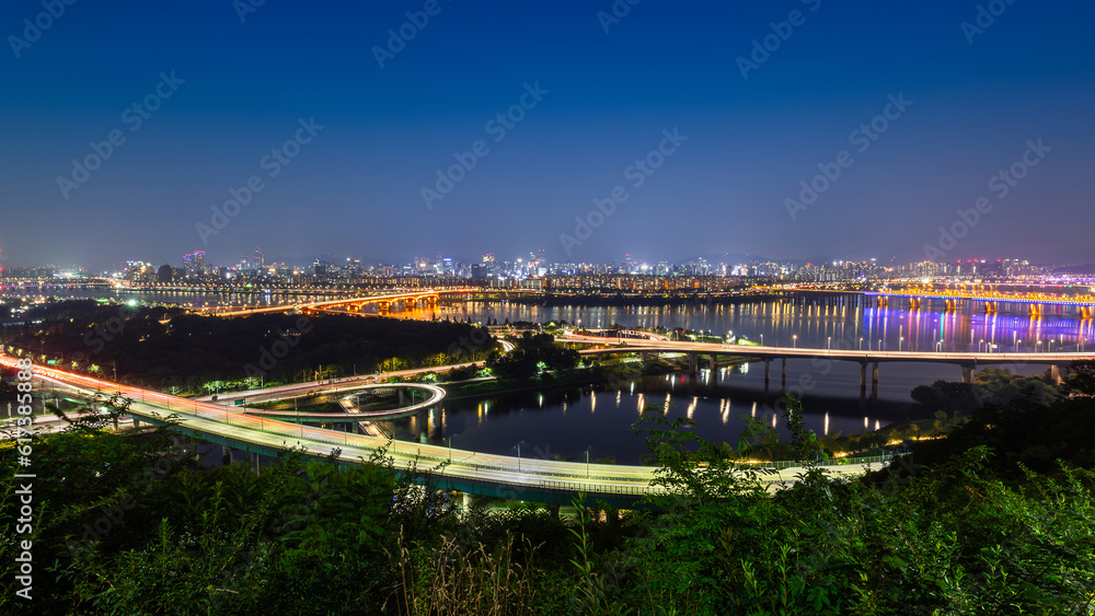 Night cityscape view of Seoul city in South Korea with modern architecture and the light of transportation